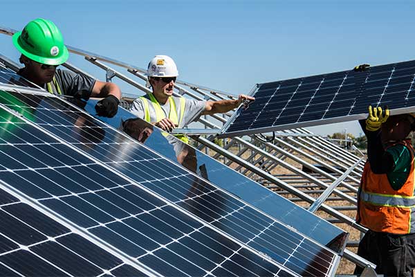 Solar installation team fitting photovoltaic panels